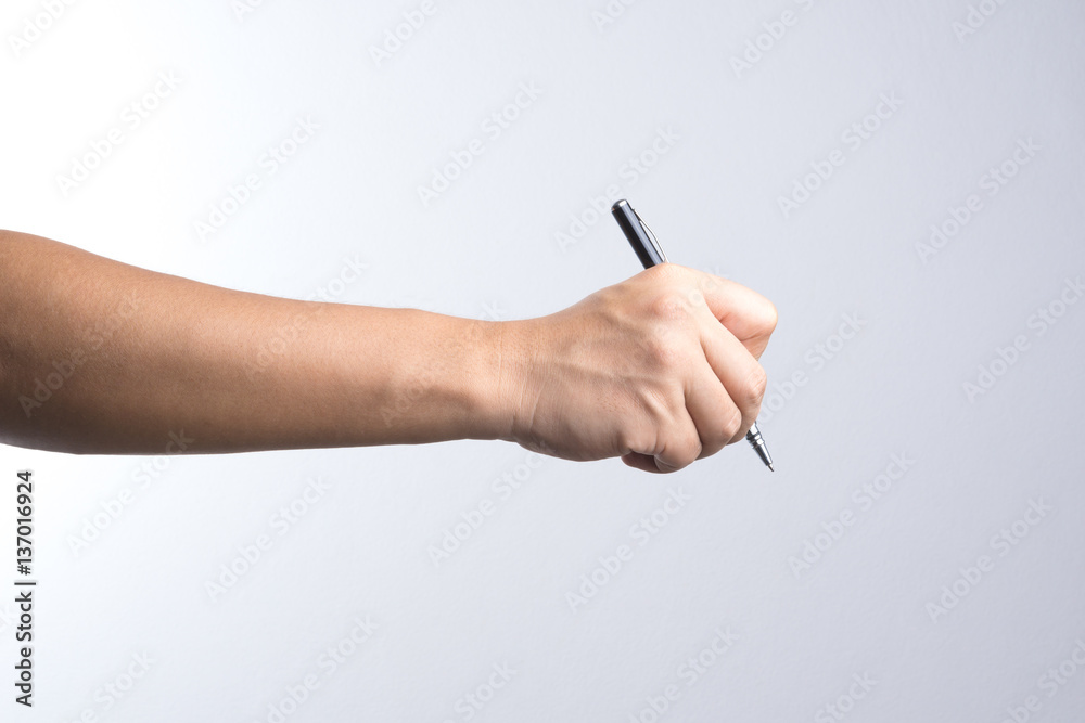 Hand holding a pen for signing or writing Hand holding a pen for signing or writing