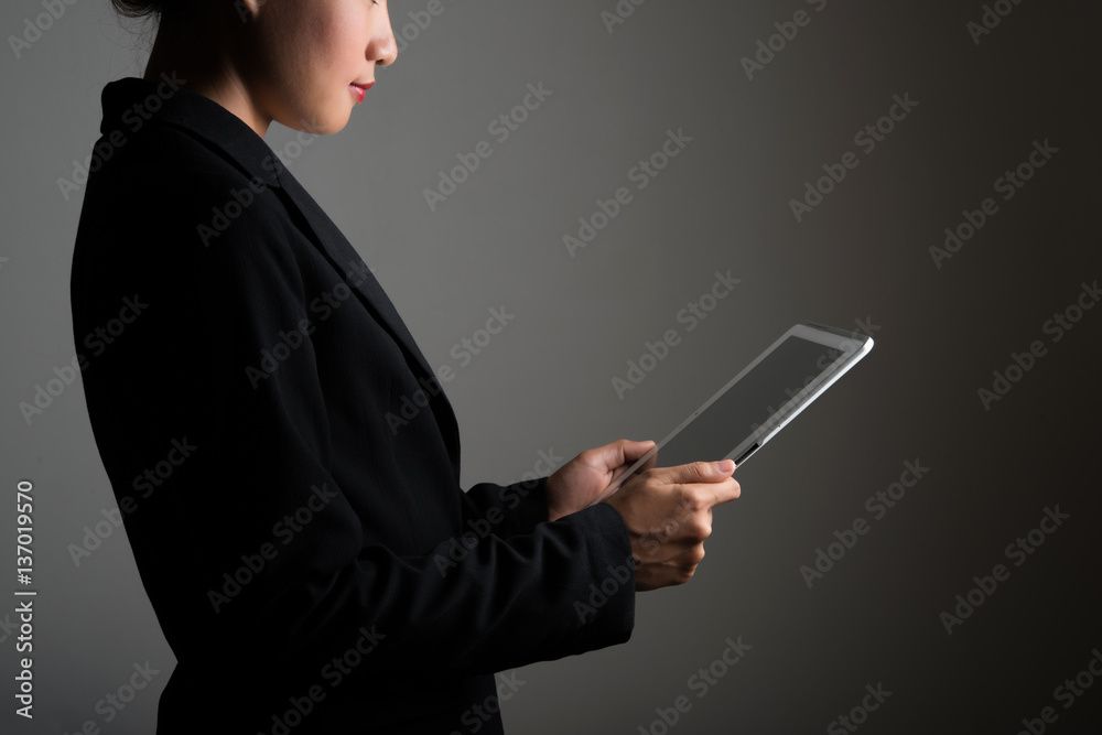 Woman holding on digital tablet and looking on a blank screen. Woman holding on digital tablet and looking on a blank screen.