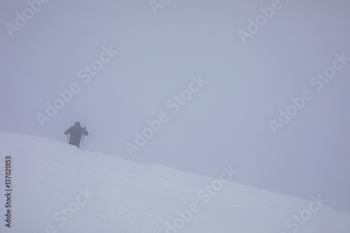 Human hiking  in snow storm.