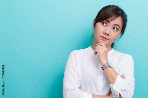 Asian woman thinking on isolated background