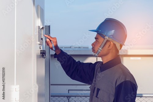 engineer or electrician working on checking and inspect equipment with checklist at outdoor industry 