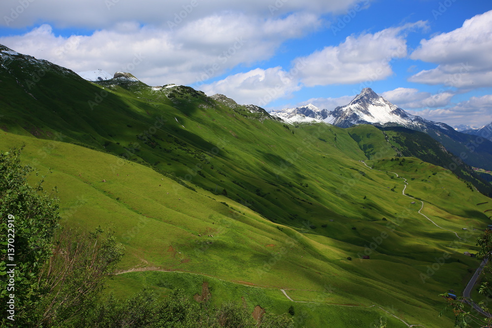 Mountain landscape with green meadows and sunshine Mountain landscape with green meadows and sunshine