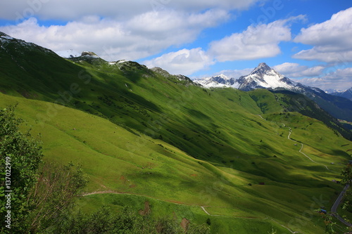Mountain landscape with green meadows and sunshine