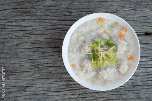 Traditional porridge rice with pork in white bowl.