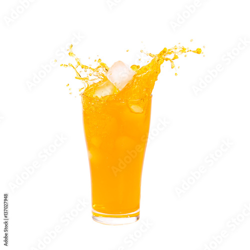 Orange juice splashing out of glass on Isolated white background.