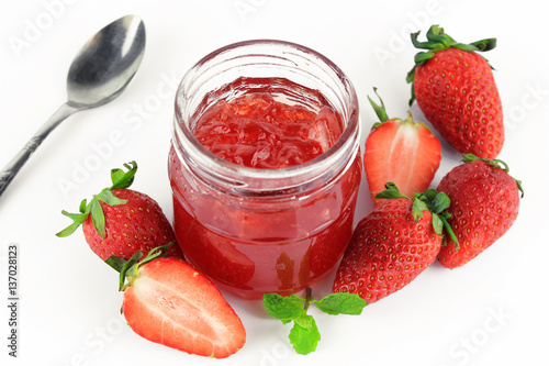 fresh strawberry jam in glass bottle with mint leaf