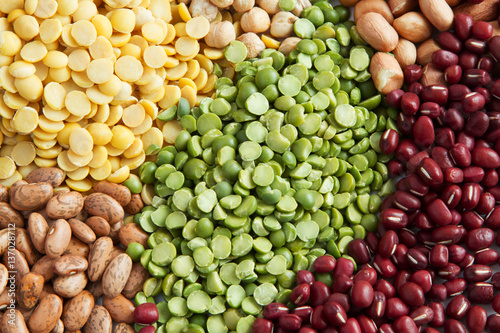 Green peas with various legumes background, top view