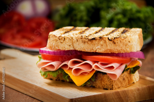 Sandwich with ham on a wooden table