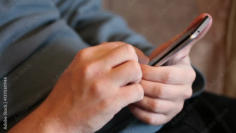 man uses the phone. Hands close-up man uses the phone. Hands close-up