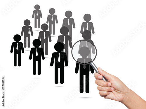 Hiring staff concept. Hand with magnifying glass finding and rec