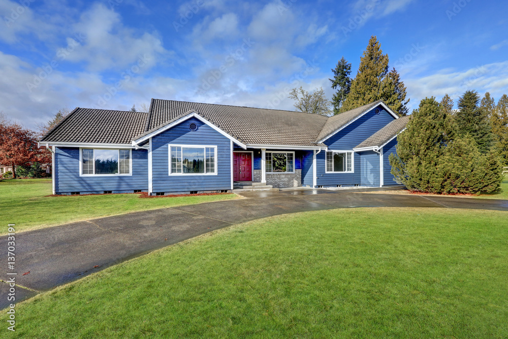 Beautiful blue rambler house with tile roof