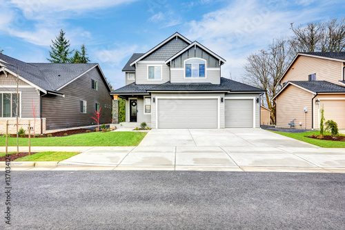 Grey house exterior on a blue sky background
