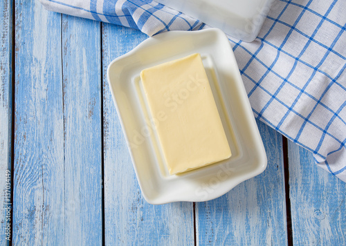 butter on butter dish on blue wooden surface