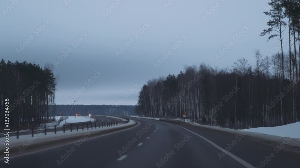 Winter road, winter forest, the view out of the car, car rides. 4k footage. Winter road, winter forest, the view out of the car, car rides. 4k footage.