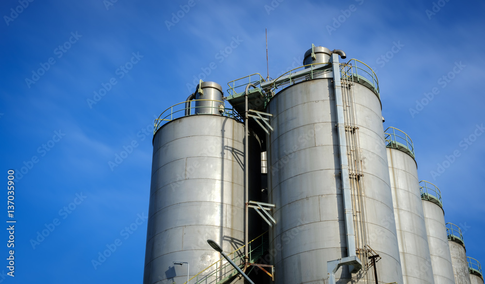 silos in petrochemical plant with blue sky