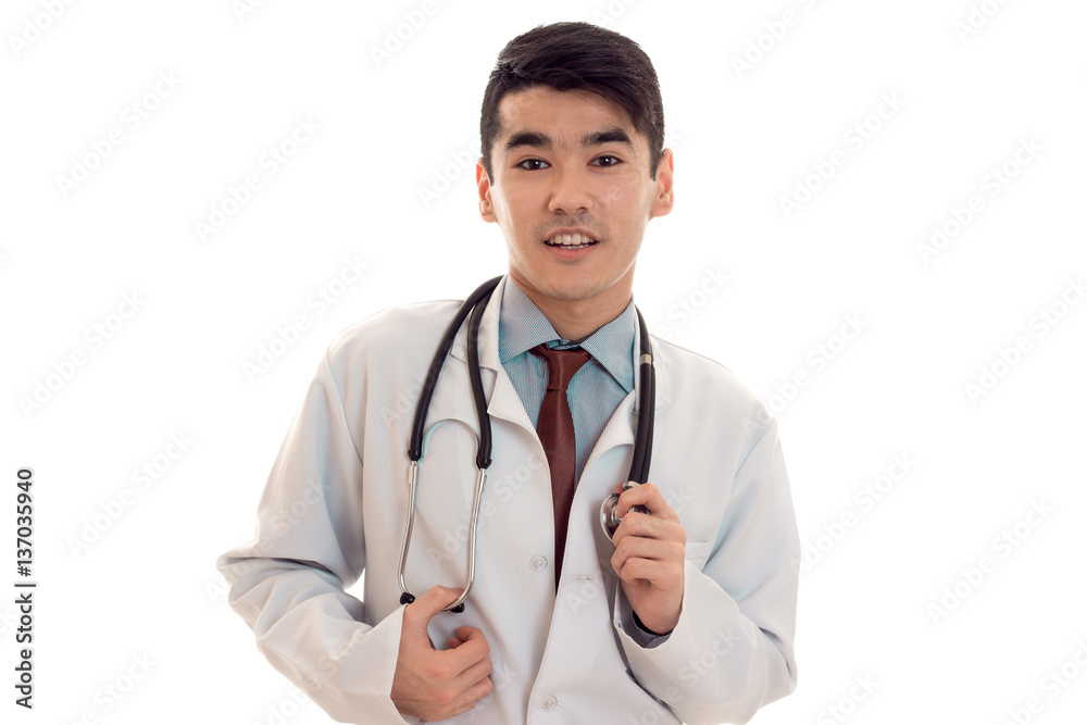 young elegant brunette doctor in uniform with stethoscope looking at the camera and smiling isolated on white background young elegant brunette doctor in uniform with stethoscope looking at the camera and smiling isolated on white background
