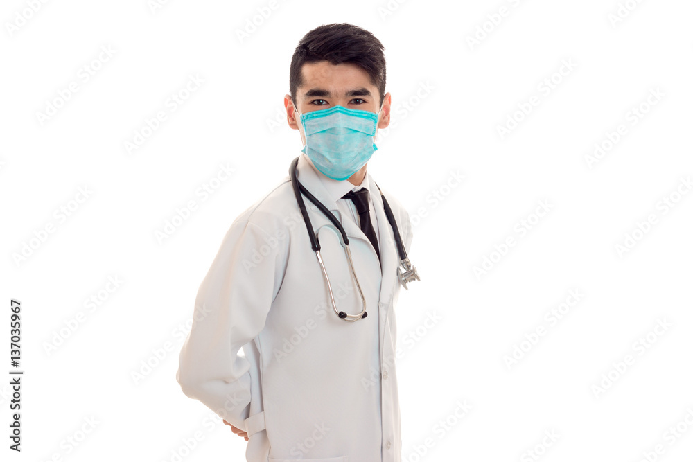 young elegant brunette doctor in uniform and mask with stethoscope isolated on white background