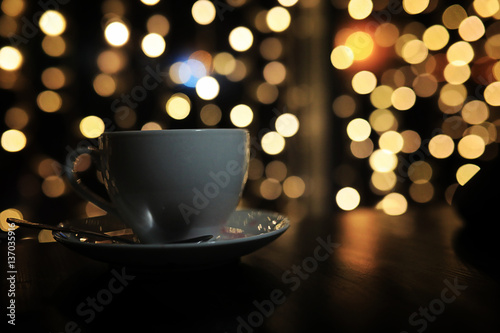 cup of coffee on the table on blured background with circle boke