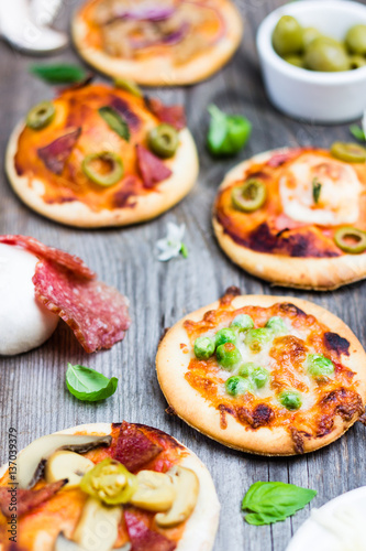 Pizza with Raw Ingredients on Wooden Background