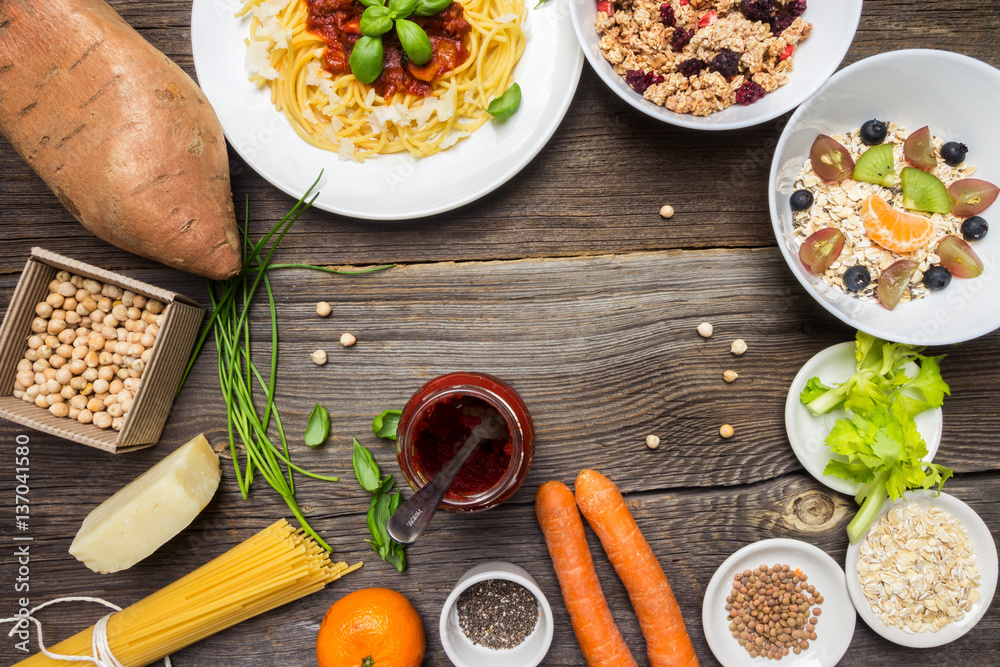 Top View Vegetarian Food and Raw Ingredients on Wooden Background Top View Vegetarian Food and Raw Ingredients on Wooden Background