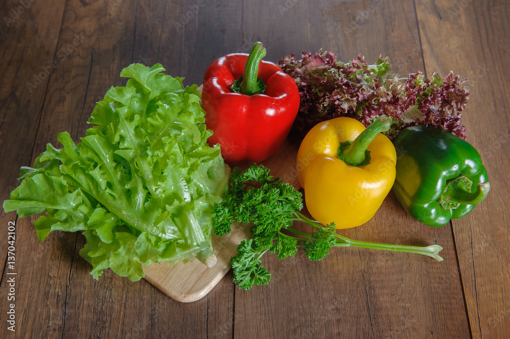 Border of fresh organic vegetables on wood background