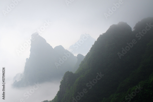 Photo of Huge Rock Mountain Silhouette with White Mist. Epic Mountain Landscape