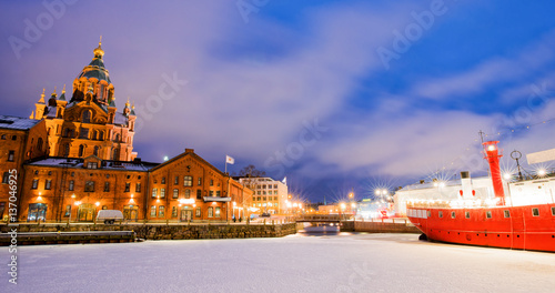 Scenic winter view the frozen Old Port in Katajanokka district with Uspenski Orthodox Cathedral in Helsinki, Finland