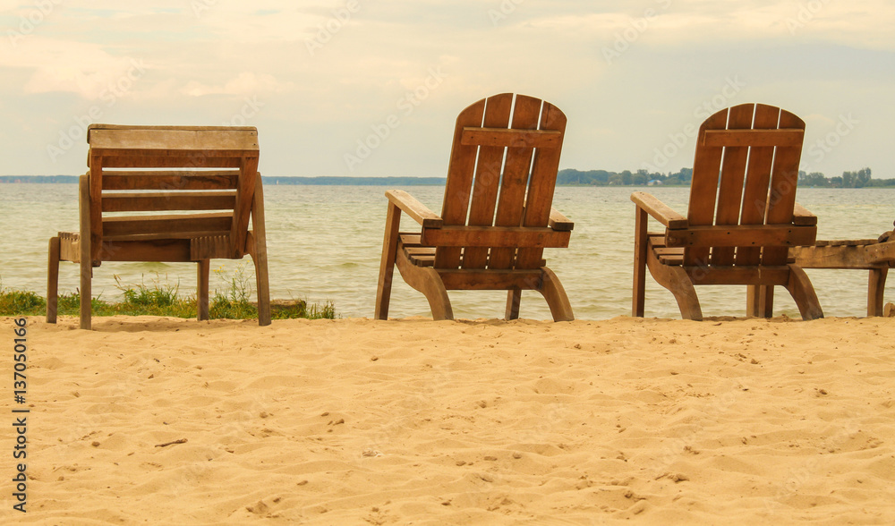 Wooden chairs at lake beach, summer holiday concept