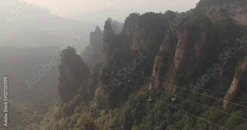 Aerial view of moving cable cars with mist in Tianmen mountain Zhangjiajie National Park, Hunan province, China.