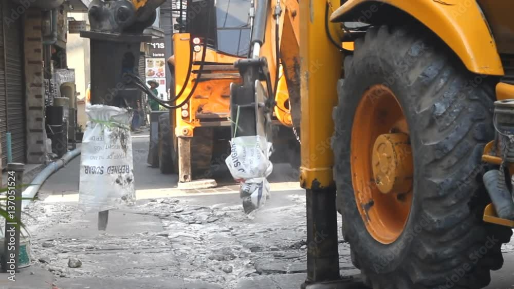 Hydraulic jack hammer is breaking concrete road Hydraulic jack hammer is breaking concrete road
