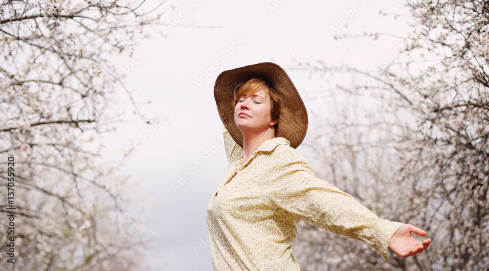 Happy woman in spring blossom park. soft backlight Happy woman in spring blossom park. soft backlight