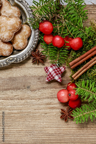 Christmas background with moss, fir, hypericum, gingerbread cook