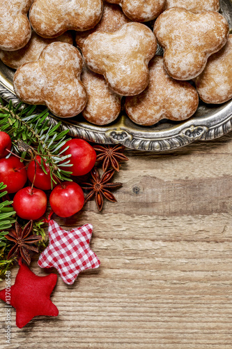 Christmas background with moss, fir, hypericum, gingerbread cook