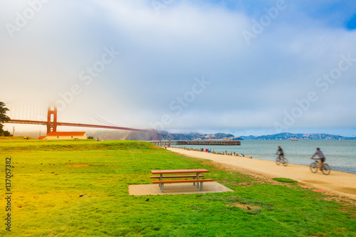Golden Gate Bridge with fog from Crissy Field, San Francisco, California, United States. Crissy Field with scenic views is popular for locals and tourists. Leisure and recreational activities concept. photo