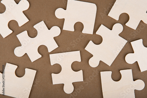 Puzzle pieces on a brown background