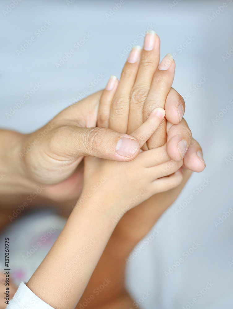 Loving hands clasped of Family father, mother and daughter.