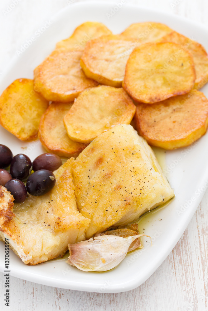 fried cod fish with potato on white dish fried cod fish with potato on white dish
