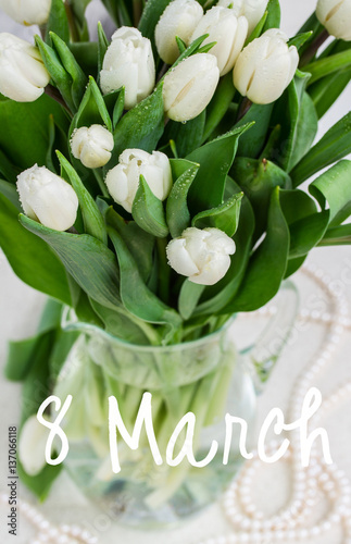 bouquet of fresh white tulips in vase on table 8 March international womens day
