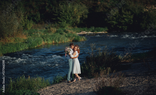 Fototapeta Naklejka Na Ścianę i Meble -  the bride and groom on the background of a mountain stream