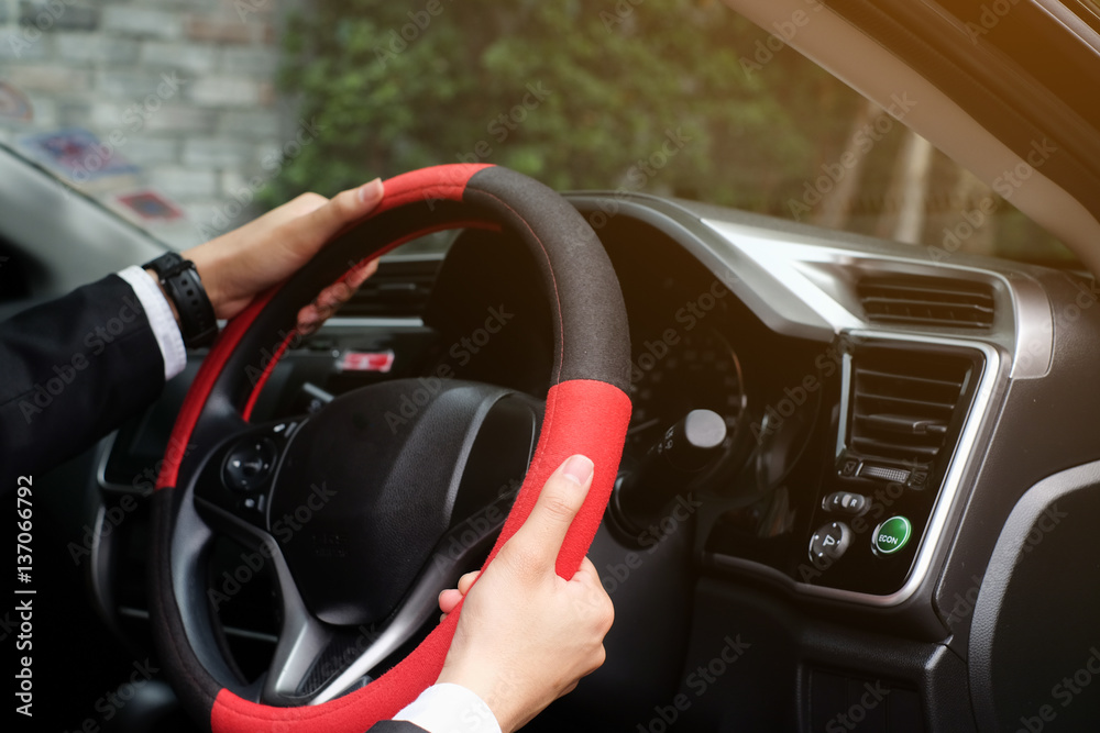 close up businessman hand holding steering wheel in the saloon car:man driving automobile vehicle concept.transportation concept.