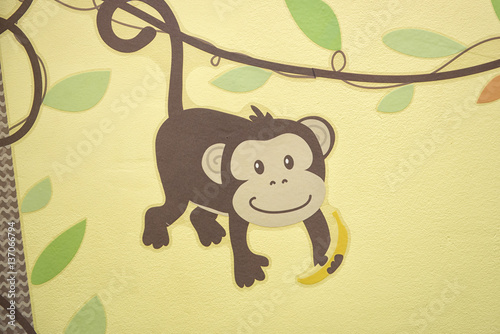 Photography Drawn little monkey on a yellow wall