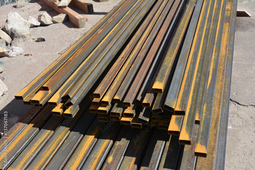 Rust steel beams, iron bar on house construction site outdoor. Steel trusses for roofing.