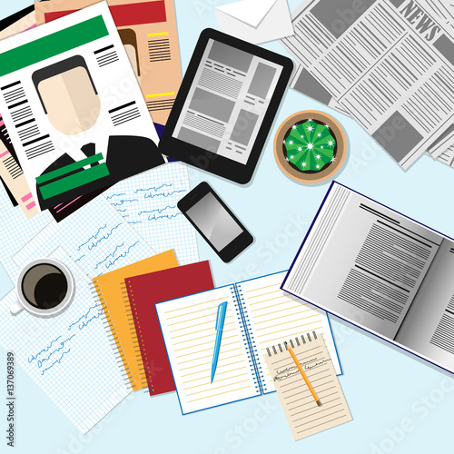 Top view of workplace with computer devices, magazines, newspape