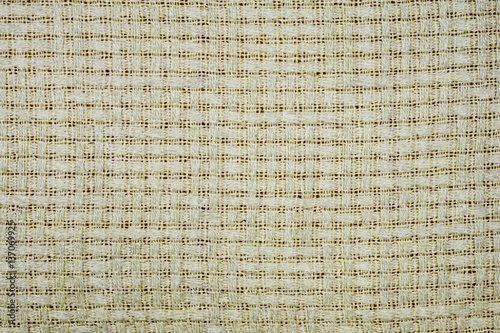 white-gray fabric with visible lines of threads and a cross-style pattern Close-up on gray background full frameed