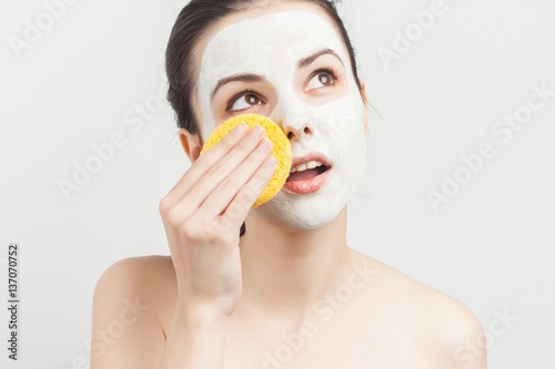 woman wiping her mask with a sponge