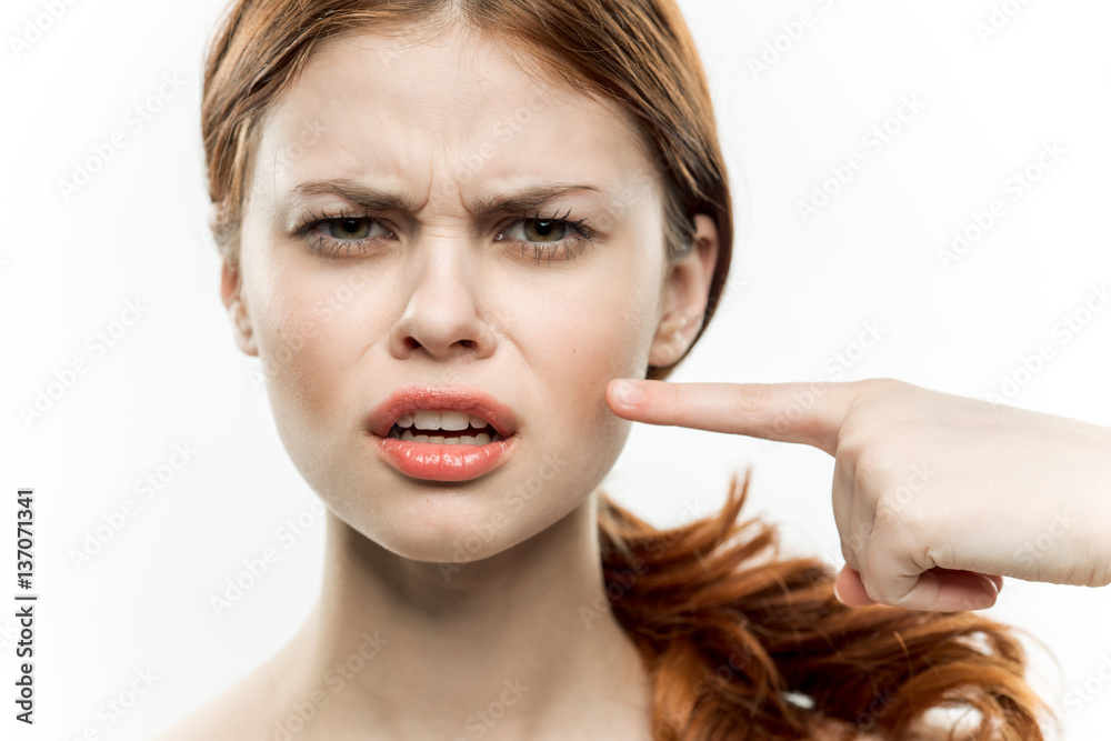 Fototapeta premium emotional woman shows a finger to the side