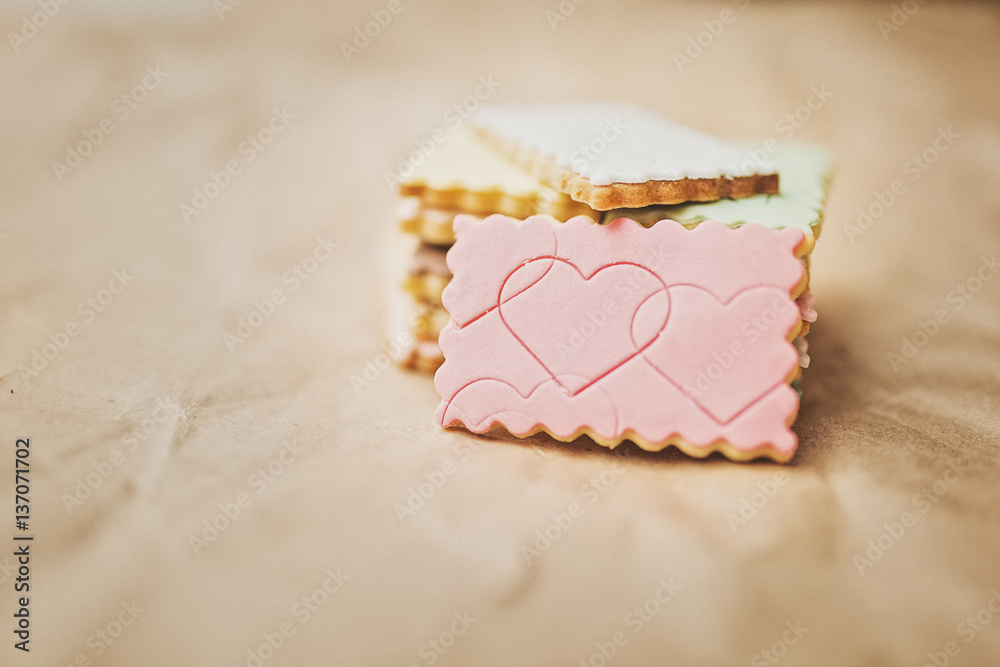Sweet colored cookies stacked on brown paper Sweet colored cookies stacked on brown paper