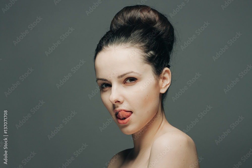 brunette with a bunch on her head licking her lip brunette with a bunch on her head licking her lip