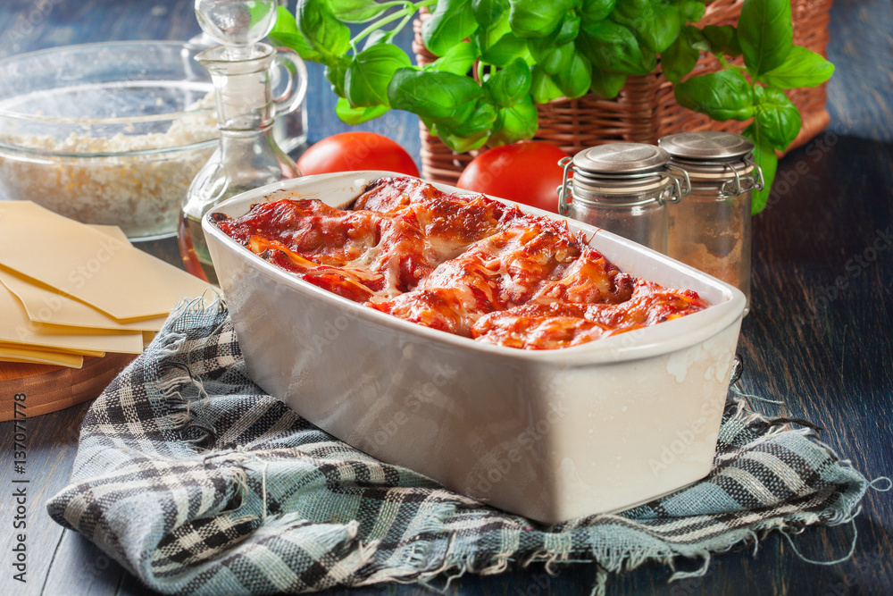 Hot tasty lasagna with spinach in ceramic casserole dish Hot tasty lasagna with spinach in ceramic casserole dish