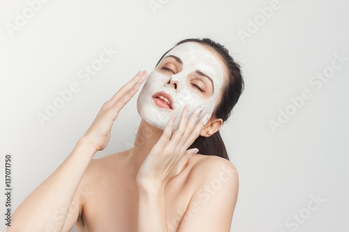 Roll with cream on face brings hands to face